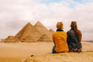 Two tourists watching the Pyramids of Giza during an Egypt tour with Got Trip